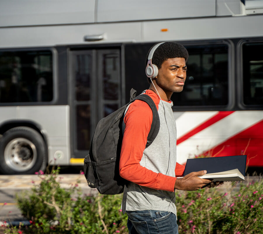 Image: Student in front of VIA Bus